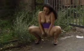 Busty brunette peeing outdoor