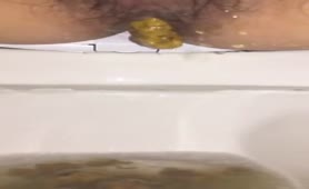 Hairy babe shits over toilet