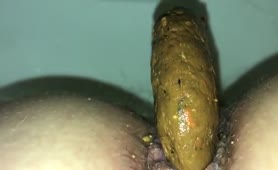 Brown turd dropped in toilet