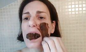 Dark haired beauty smears poop on face