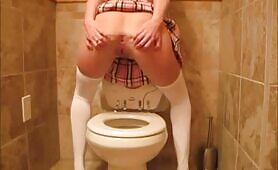 Pretty brunette schoolgirl poops in the toilet 