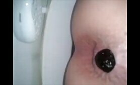 Girl shitting a dark turd closeup 