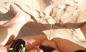 Fat lady pissing and pooping on the sand 