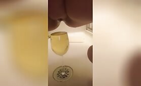 Peeing in a wine glass and pouring it down  on her boobs 