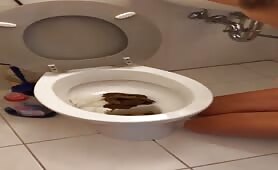 Woman eats from toilet