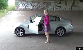 Mature woman shits by her car