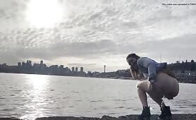 Lady shits by the water