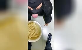 Blonde Man Eats Noodles While Wearing Black Bodysuit